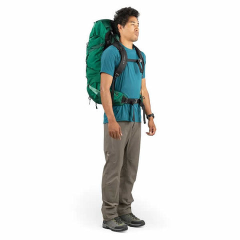 Osprey Rook 60 Litre Men's Hiking Backpack Mallard Green side view in use