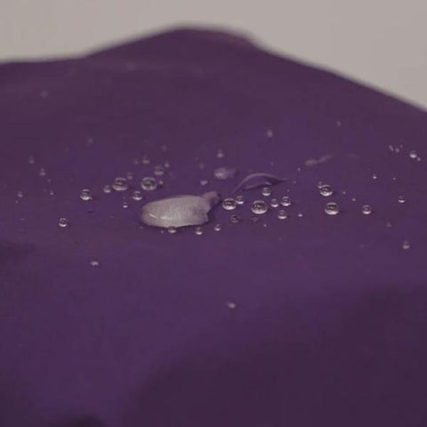 Revivex Durable Water Repellent Spray Bottle showing water beading on jacket